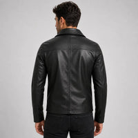 Man wearing a black leather jacket on a gray background