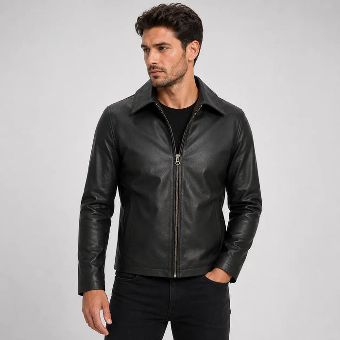 Man wearing a black leather jacket on a gray background