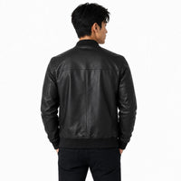 Person wearing a black leather jacket on a white background