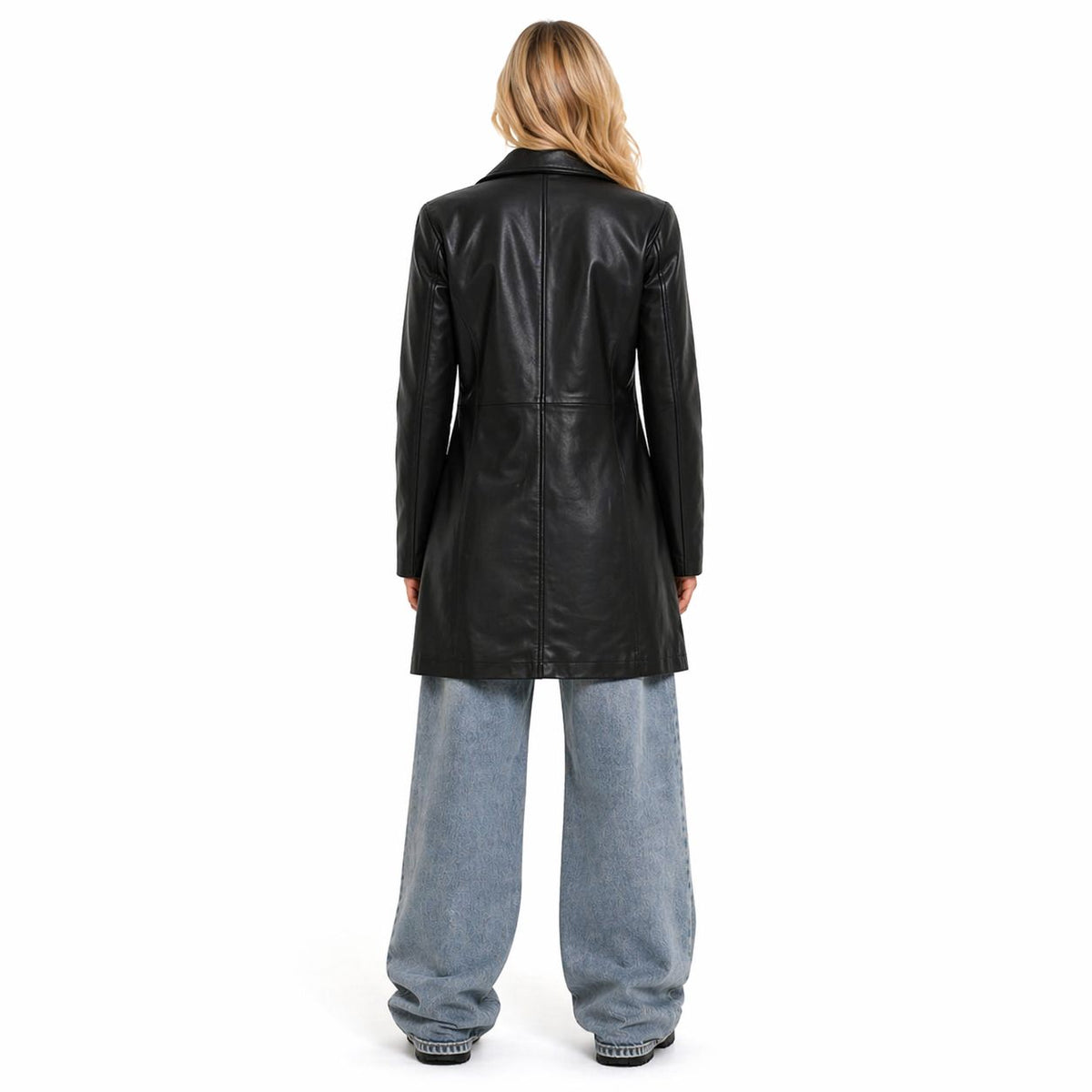Woman wearing a black Genuine leather coat and light blue jeans on a white background