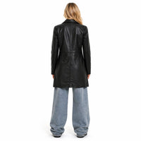 Woman wearing a black Genuine leather coat and light blue jeans on a white background